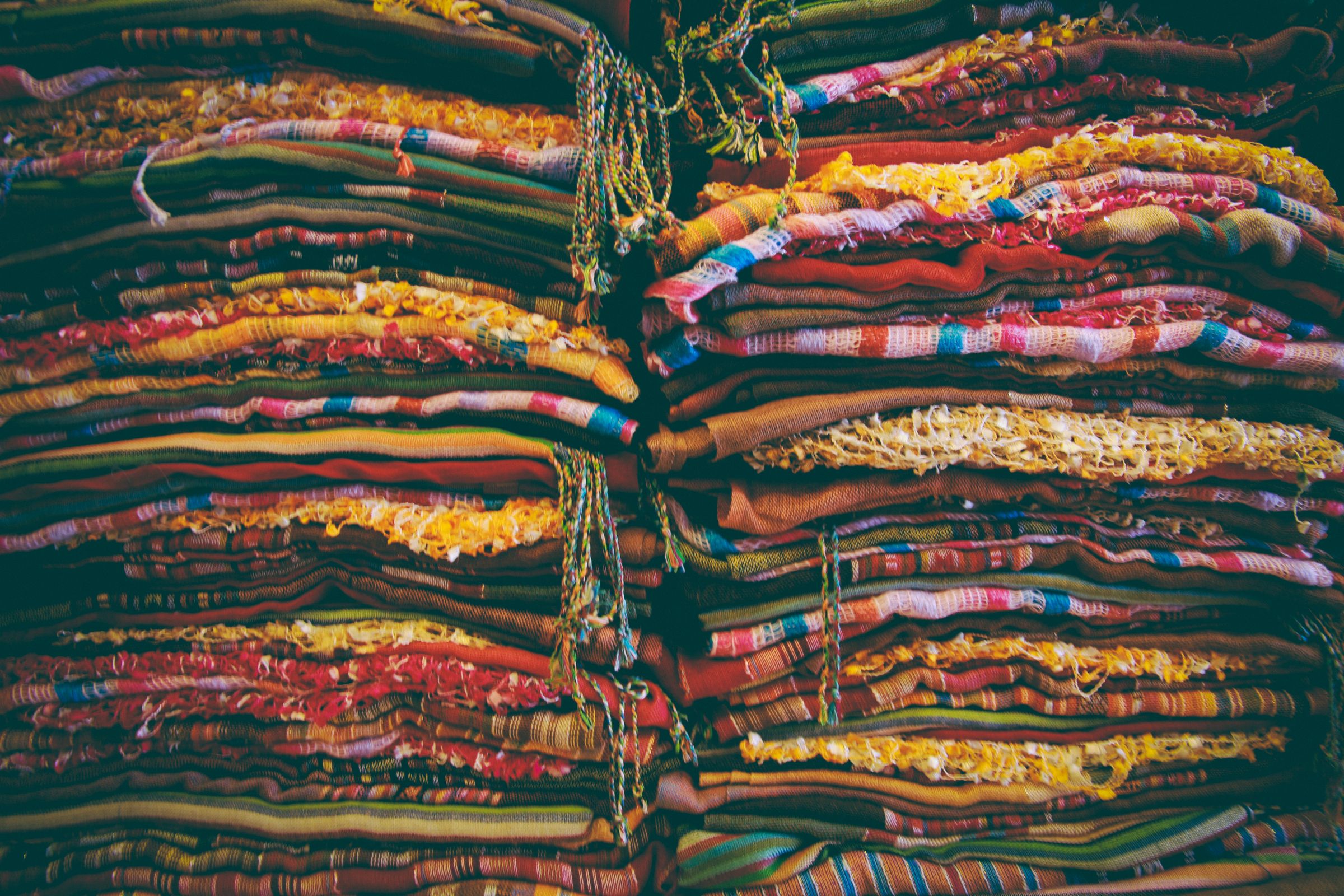 Bolts of fabric stacked in a textile store